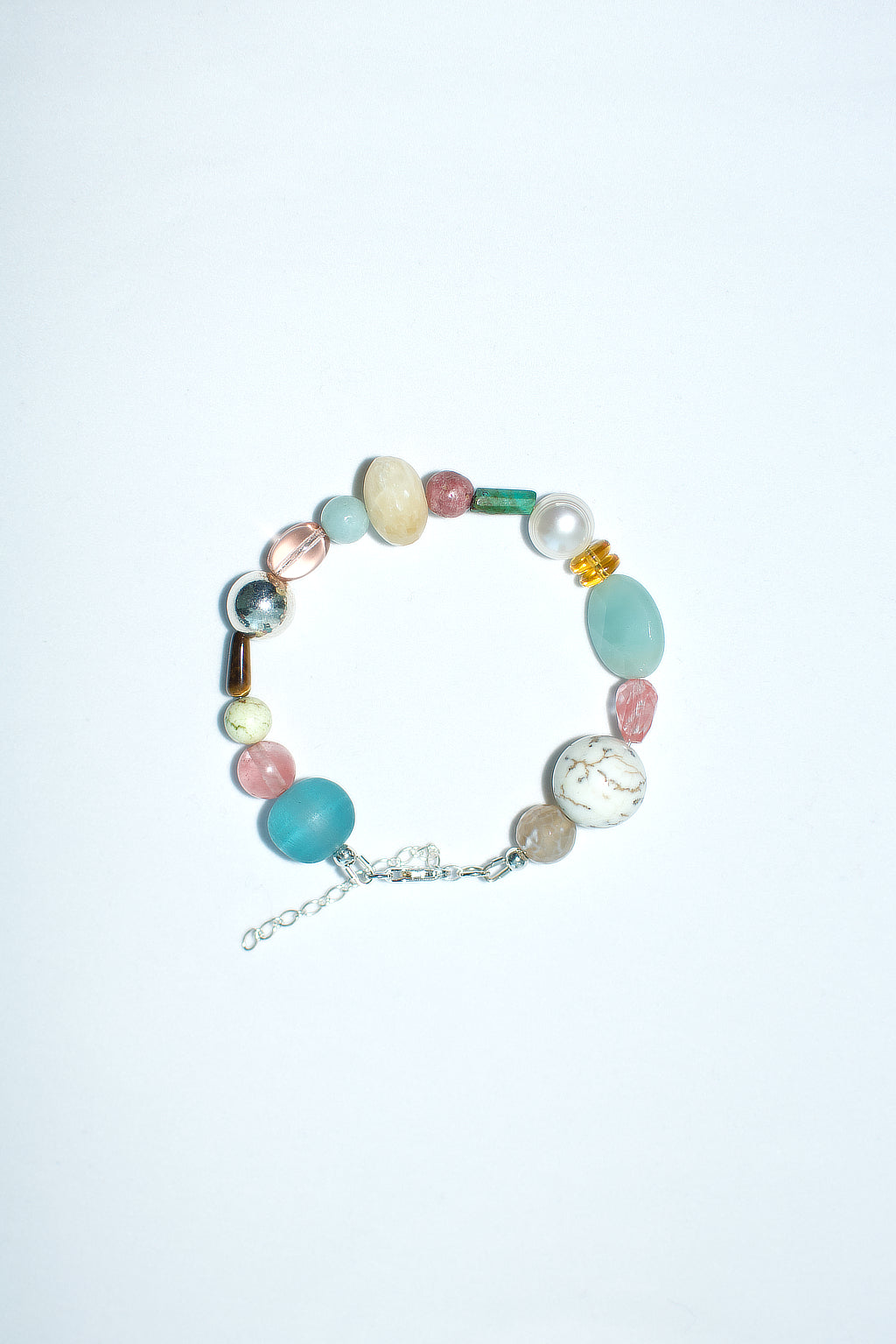 Semiprecious gemstone bracelet featuring an assortment of semi-precious, pearl, glass and resin beads.